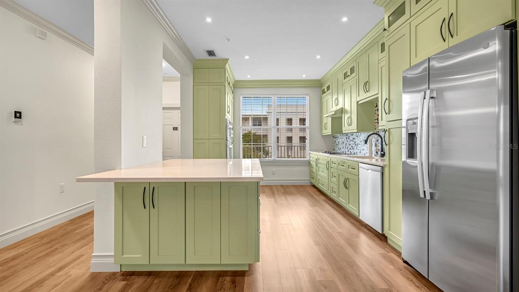 A bedroom features a king bed, a bench, two nightstands, and a balcony with doors — 4286 ANISSA AVENUE UNIT 10-202, ORLANDO, FL