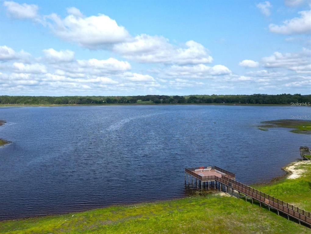 An elevated view of a lake with a wooden pier extending from the grassy shore — 00 SW BREAKWATER BOULEVARD, DUNNELLON, FL