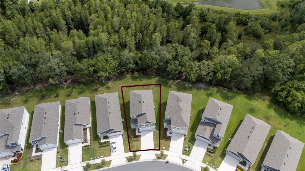 An aerial view shows a suburban house highlighted in red within a cul-de-sac neighborhood — 4385 TWISTED TWIG BEND, KISSIMMEE, FL