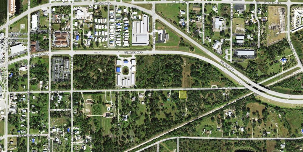 This aerial map shows a vacant lot highlighted in yellow along a residential road — 1813 LAVILLA ROAD, PUNTA GORDA, FL