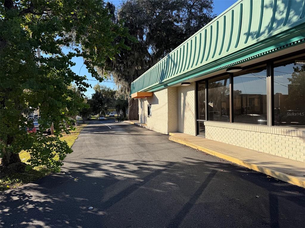 A view of a brick commercial building exterior with a drive-thru window and parking lot — 1536 S PINE AVENUE, OCALA, FL