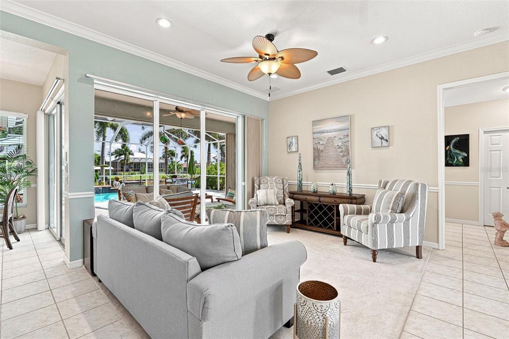 A single-story house with a light blue exterior, a two-car garage, and two palm trees — 136 PECKHAM STREET SE, PORT CHARLOTTE, FL