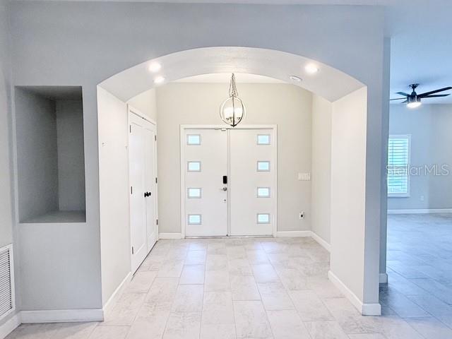 An entryway features a white double door, arched ceiling, pendant light, and light-colored tile flooring — 2408 CORRINE DRIVE, ORLANDO, FL