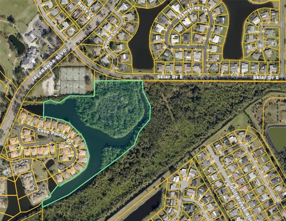 This is an aerial map showing a vacant, wooded lot bordered by a lake and roads — E SKLAR DRIVE, VENICE, FL