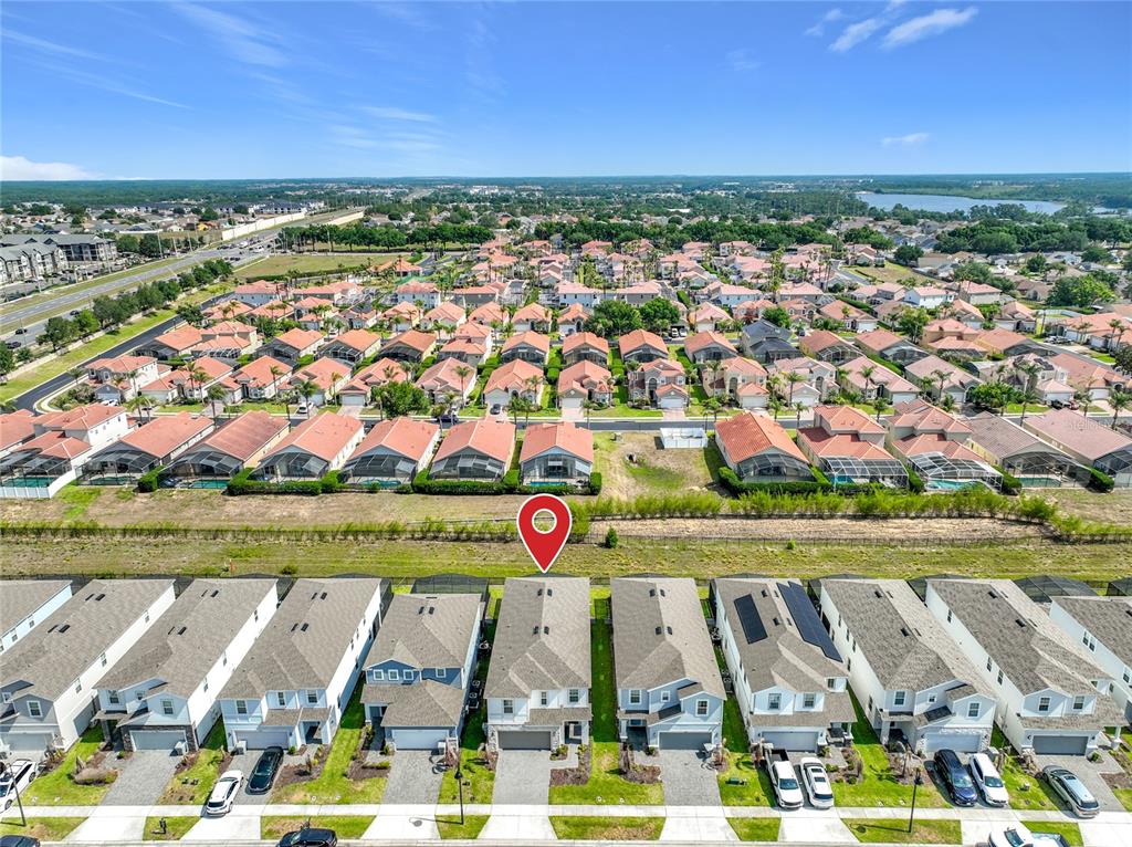 An aerial view shows a row of suburban houses with a red location pin — 4033 LANA AVENUE, DAVENPORT, FL