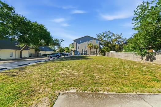 An aerial view shows a rectangular vacant lot outlined in red between existing buildings — 444 SKINNER BOULEVARD, DUNEDIN, FL