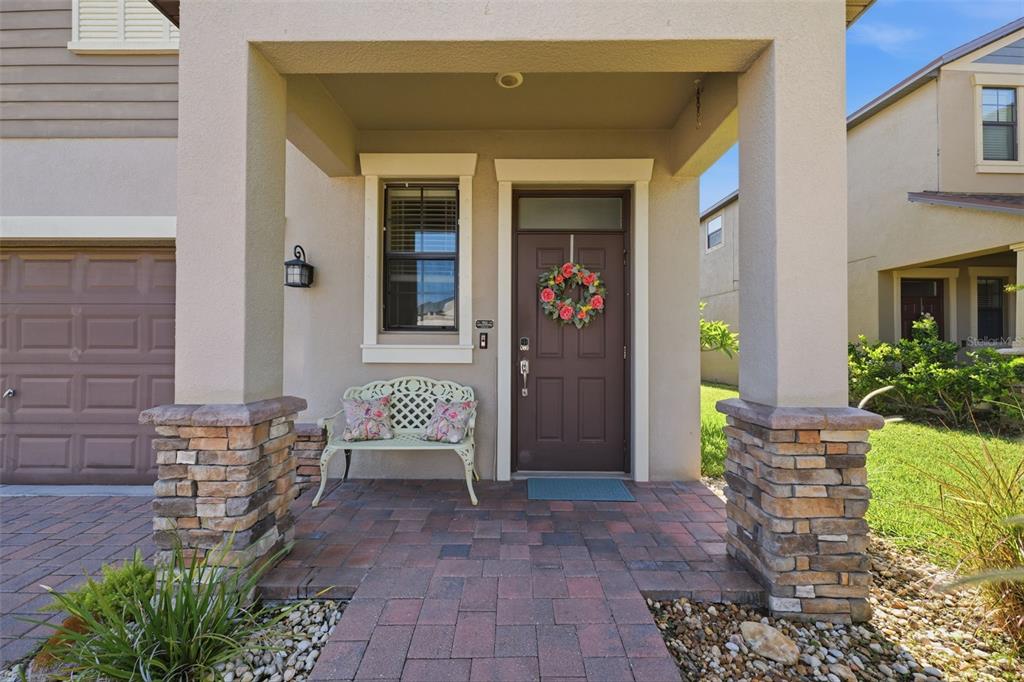 A kitchen island with granite countertops overlooks an open-concept dining area and living room — 11767 LAKE BOULEVARD, NEW PORT RICHEY, FL