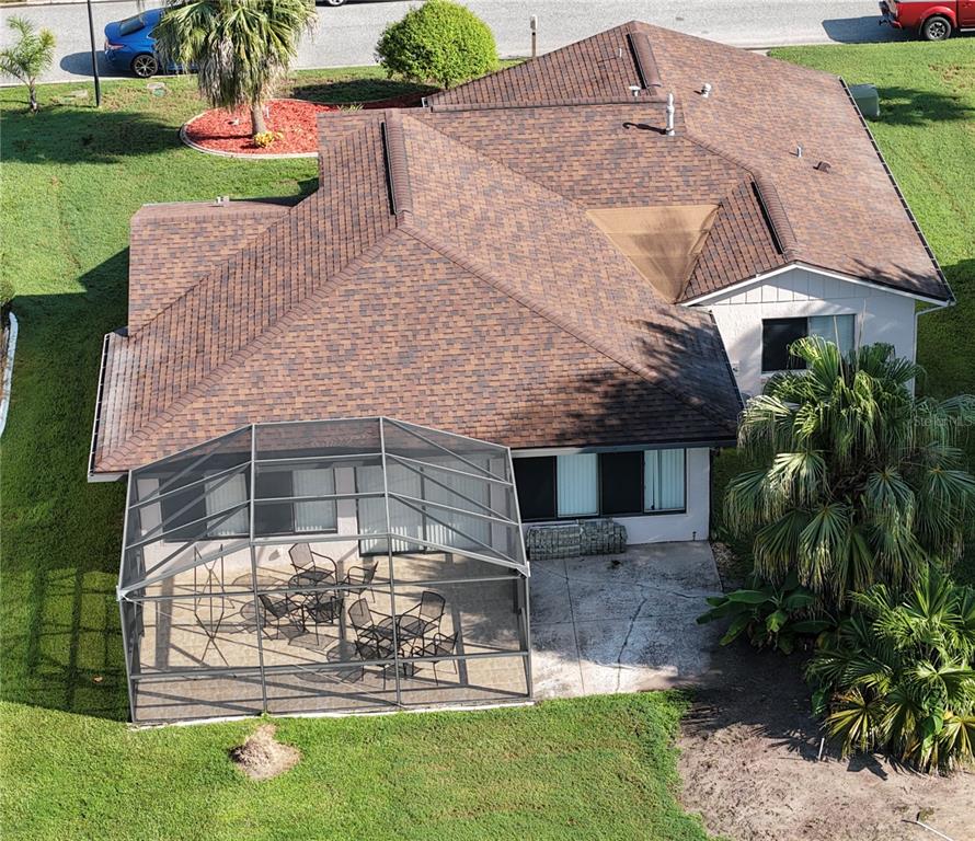 An aerial view of a house with a brown shingled roof and a screened-in patio — 11226 SCENIC VIEW LANE, ORLANDO, FL