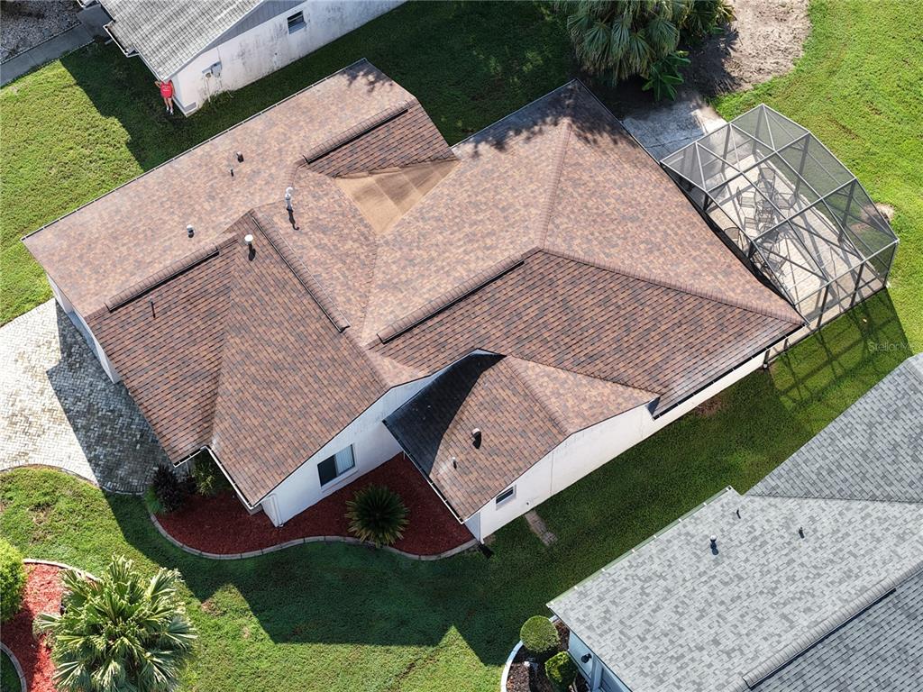 An aerial view shows a residential house with a brown shingled roof and screened patio — 11226 SCENIC VIEW LANE, ORLANDO, FL