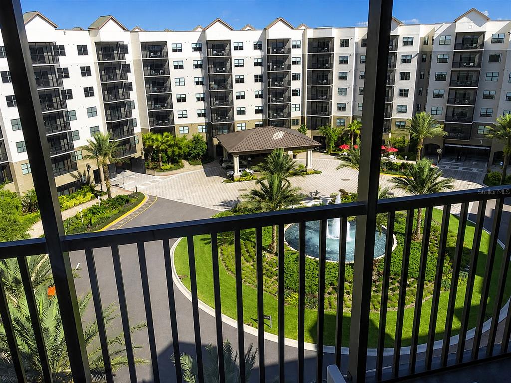 A high-angle view shows a multi-story apartment building with a circular driveway and fountain — 14501 GROVE RESORT AVE, WINTER GARDEN, FL