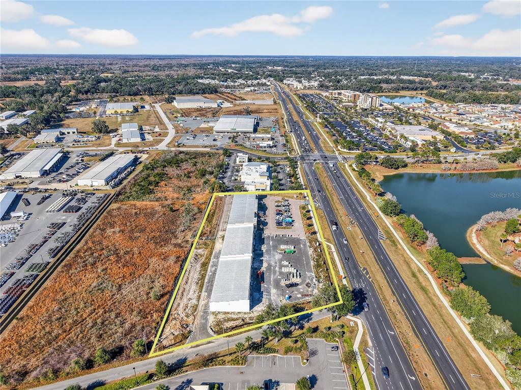 An aerial view shows a commercial building with a parking lot outlined in yellow — 4713 E STATE ROAD 44, WILDWOOD, FL