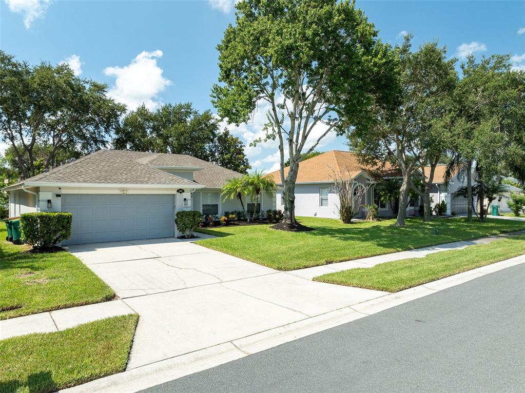 A street-level view of two single-story suburban houses with driveways and green lawns — 1373 PAYETTE LANE, WEST MELBOURNE, FL