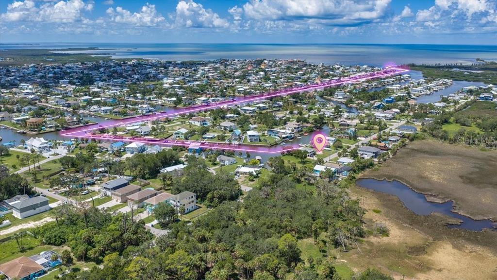 An aerial view shows a coastal neighborhood with a pink outline highlighting a specific property — 4018 EAGLE NEST DRIVE, HERNANDO BEACH, FL