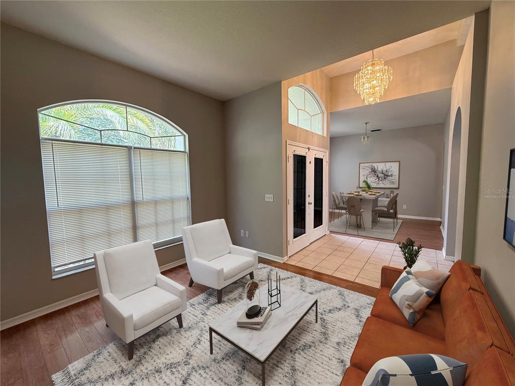 A living room with white armchairs, a marble coffee table, and an orange sofa — 3510 AUTUMN GLEN DRIVE, VALRICO, FL
