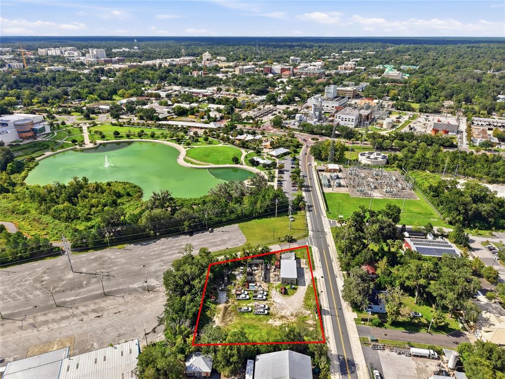 An aerial view shows a fenced, rectangular lot with a small building and parked vehicles — 916 SE 4TH STREET, GAINESVILLE, FL