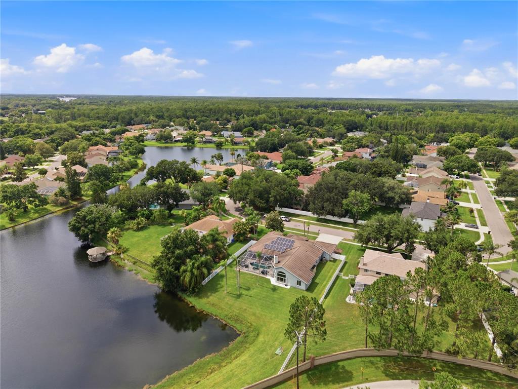 A single-story house with a gray exterior, tile roof, and a three-car garage — 17024 WINNERS CIRCLE, ODESSA, FL