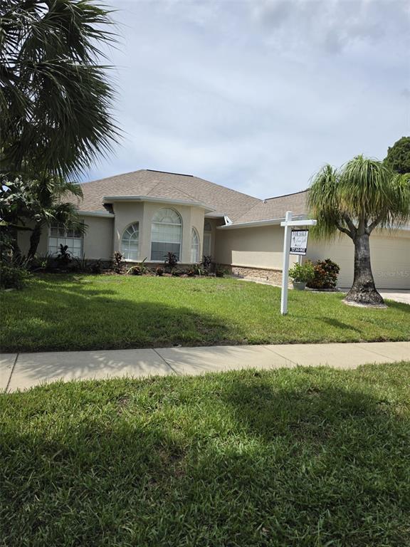 An entryway with a tiled floor and decorative inlay leads into a living area — 740 SALT LAKE DRIVE, TARPON SPRINGS, FL