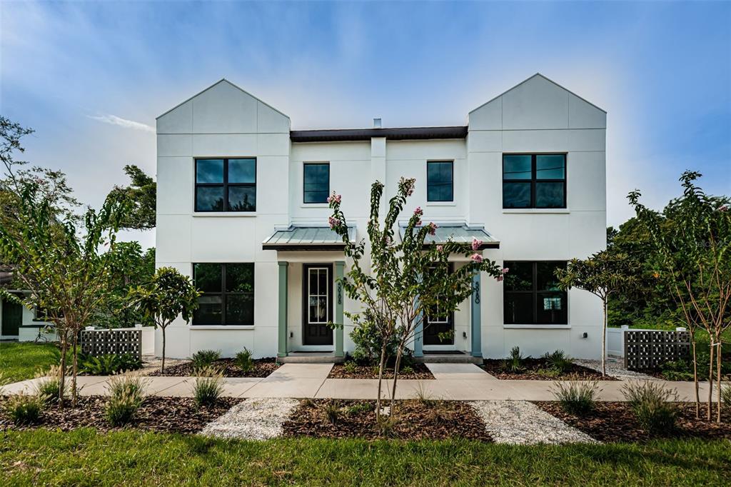 An aerial view shows a vacant lot situated between a modern duplex and a street — 5972 CENTRAL AVENUE, NEW PORT RICHEY, FL