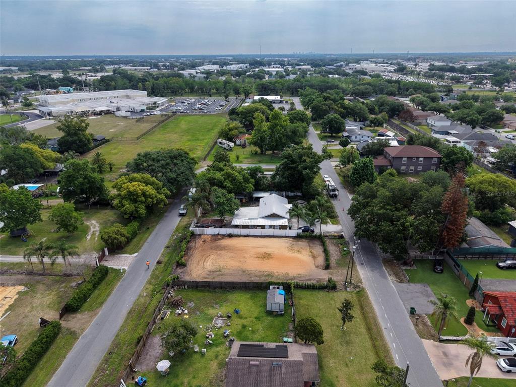 An aerial view shows a vacant, cleared rectangular lot situated between two residential streets — 441 E CYPRESS STREET, WINTER GARDEN, FL