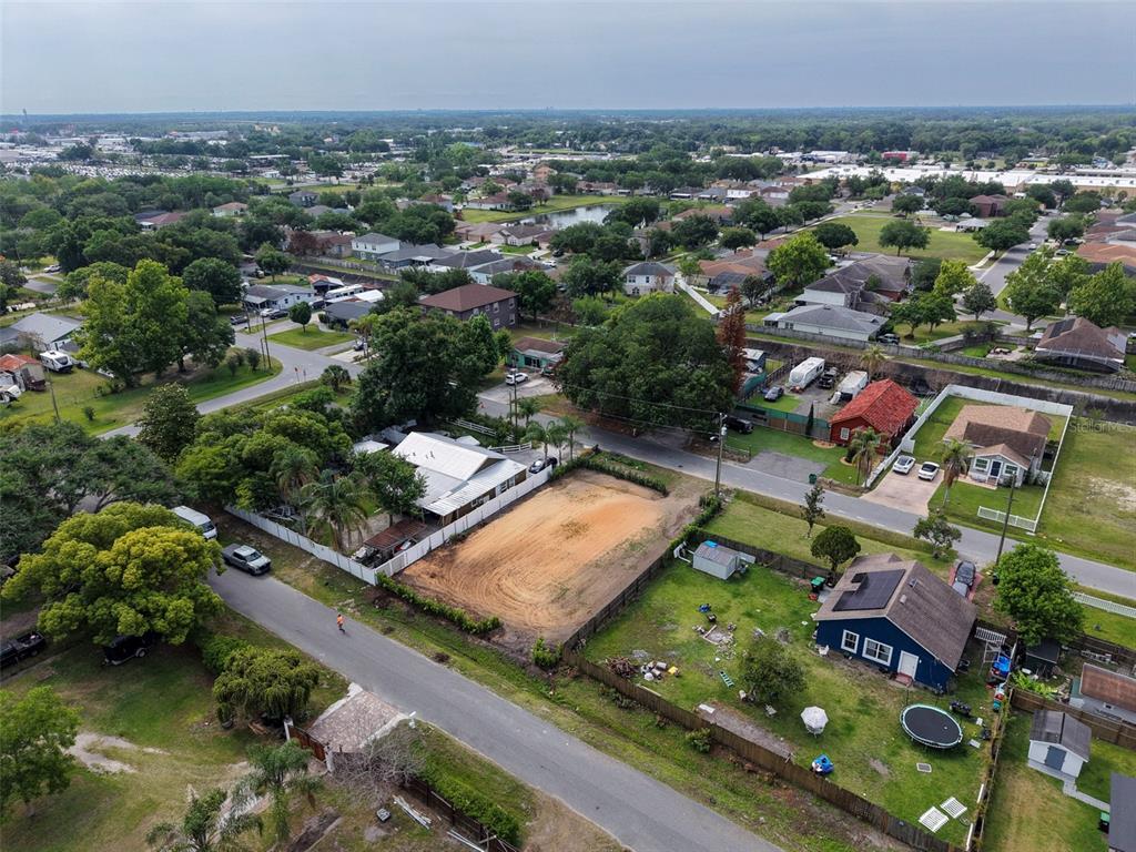 An aerial view shows a vacant sandy lot situated between two houses in a residential neighborhood — 441 E CYPRESS STREET, WINTER GARDEN, FL