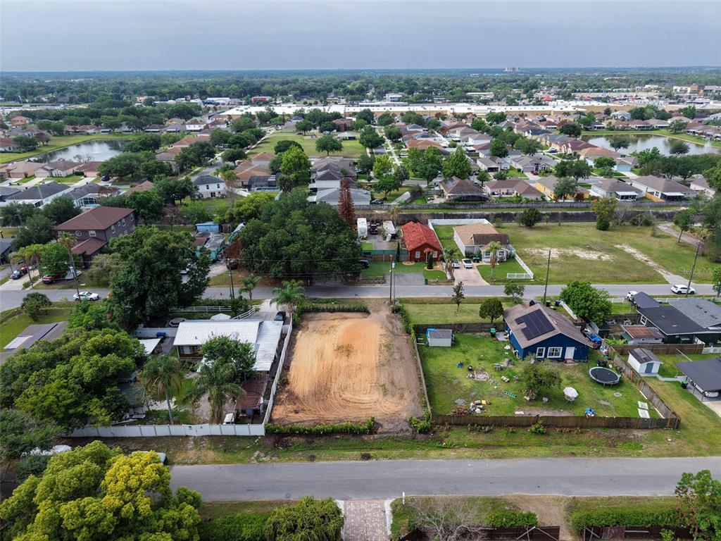 An aerial view shows a vacant rectangular lot situated between two residential houses — 441 E CYPRESS STREET, WINTER GARDEN, FL