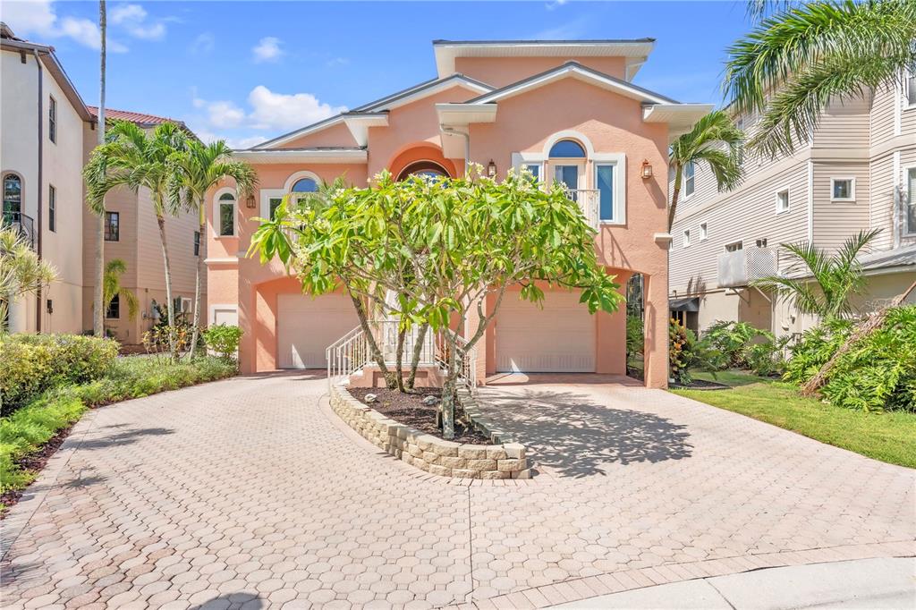 A two-story peach-colored house features a paved circular driveway and a central landscaped island — 1508 BOWLEES COVE, BRADENTON, FL