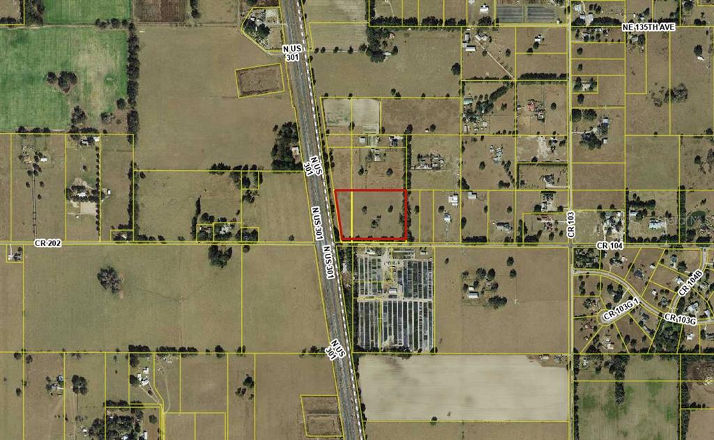 This is an aerial map showing a vacant rectangular lot outlined in red — 4040 COUNTY ROAD 104, OXFORD, FL