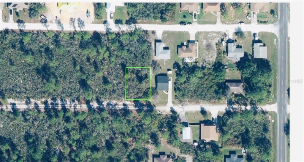 An aerial view shows a vacant rectangular lot outlined in green within a residential neighborhood — 321 BRANT AVENUE, SEBRING, FL