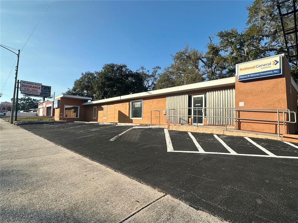 An exterior view of a single-story commercial building with a parking lot in front — 550 E BAY DRIVE, LARGO, FL