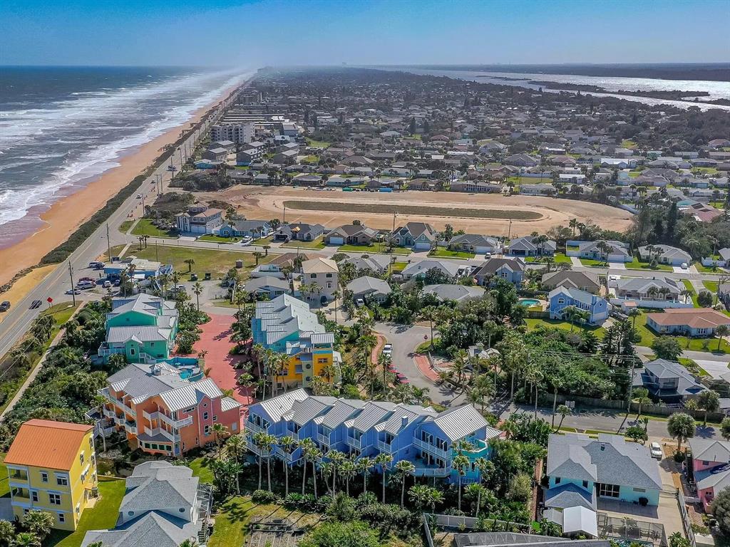 An aerial view of a coastal neighborhood featuring colorful multi-story homes near the beach — 3000 OCEAN SHORE BOULEVARD UNIT 14, ORMOND BEACH, FL