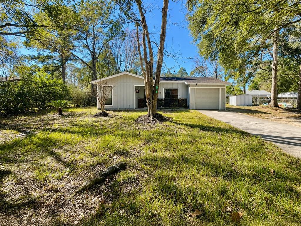 A single-story house with light gray siding, a front porch, and an attached garage — 6018 NW 26TH TERRACE, GAINESVILLE, FL