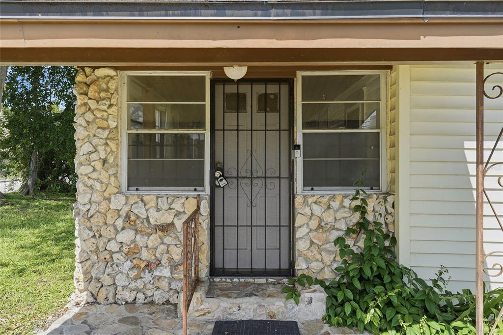 The front entrance features a stone-faced exterior, a security screen door, and a small porch — 307 LEMON STREET, MAITLAND, FL