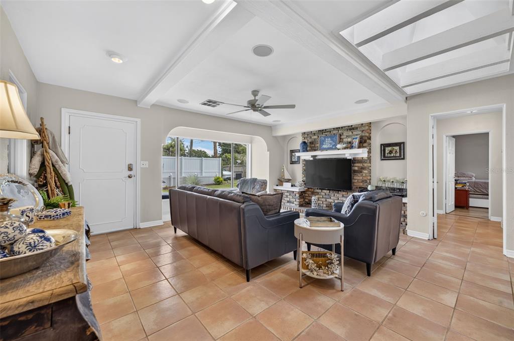 A living room features tile floors, a stone fireplace, a ceiling fan, and two leather sofas — 790 S LAKE SYBELIA DRIVE, MAITLAND, FL