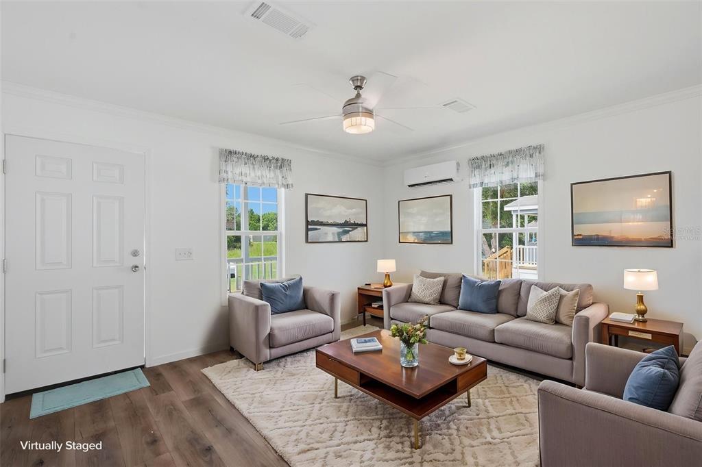 A living room features a sofa, two armchairs, a coffee table, and wood-look flooring — 4251 E HAWAII LANE, HERNANDO, FL