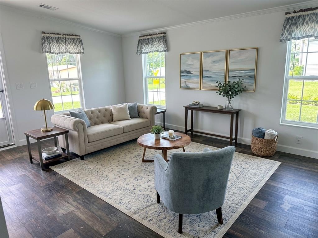 A kitchen features wood-toned cabinets, a white island with a marble-patterned countertop, and stainless appliances — 3492 GREENBLUFF ROAD UNIT 1119, ZELLWOOD, FL
