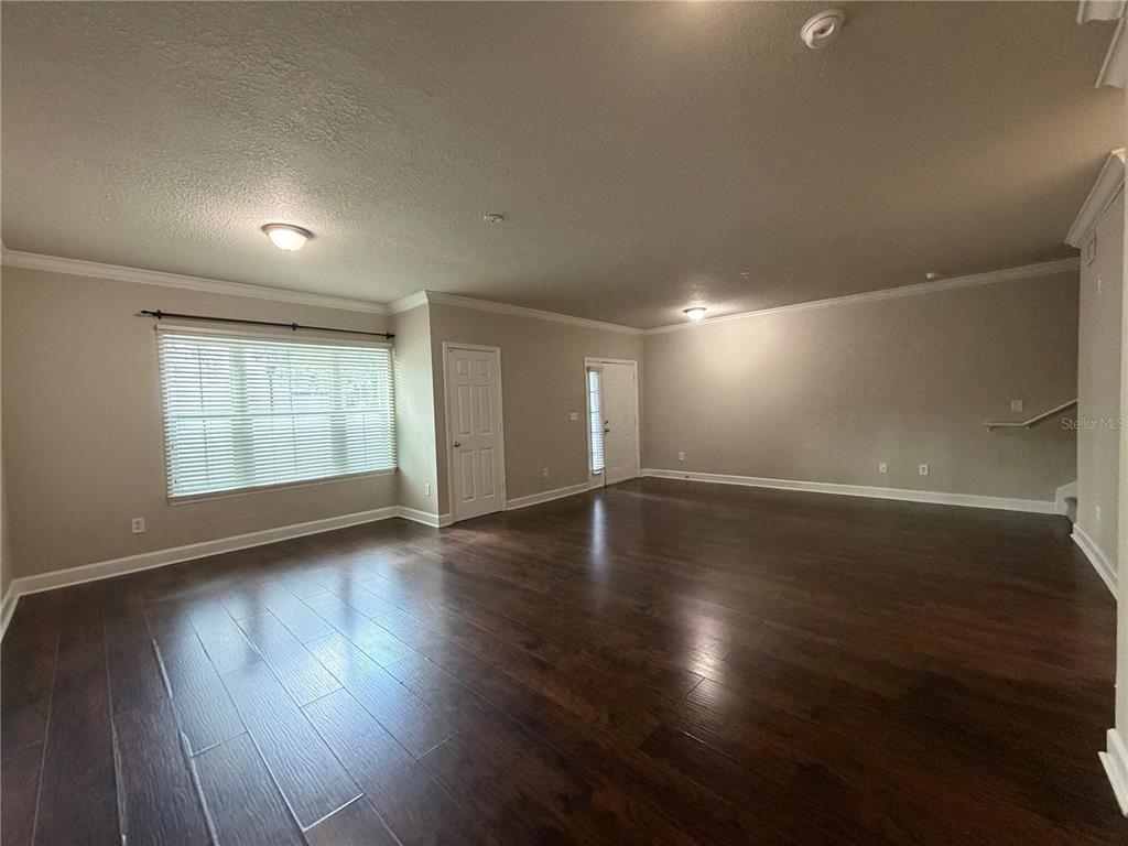 A paved courtyard features palm trees, outdoor seating, and a tiki-style bar area — 204 SOUTH STREET UNIT 1053, ORLANDO, FL