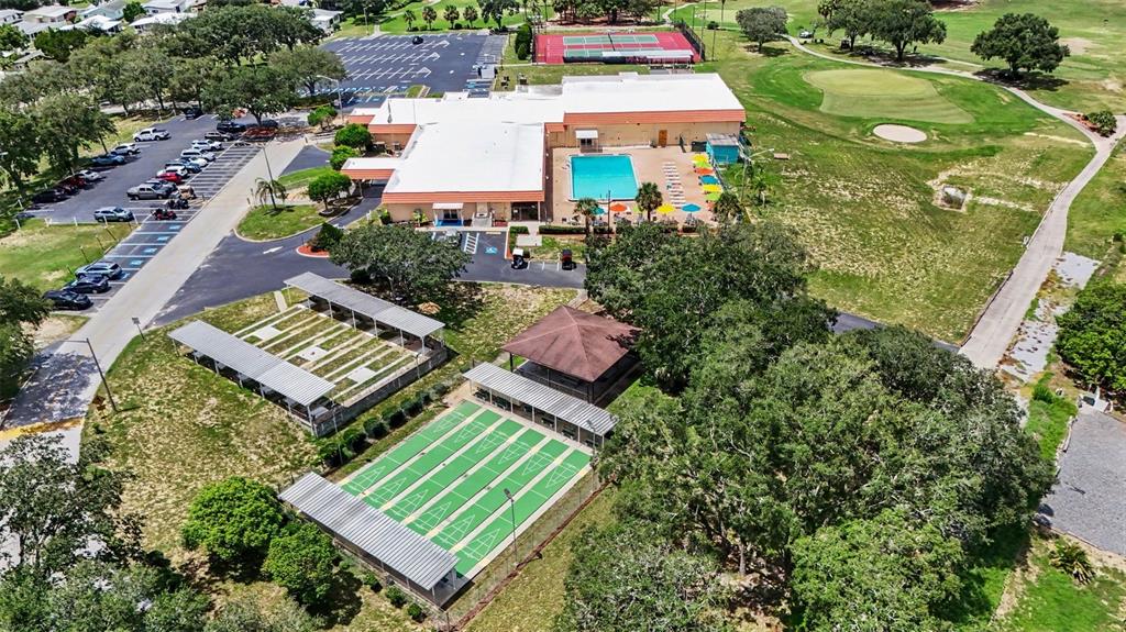 An aerial view shows a community clubhouse with a pool, tennis courts, and shuffleboard courts — 9178 ADMIRAL STREET, BROOKSVILLE, FL