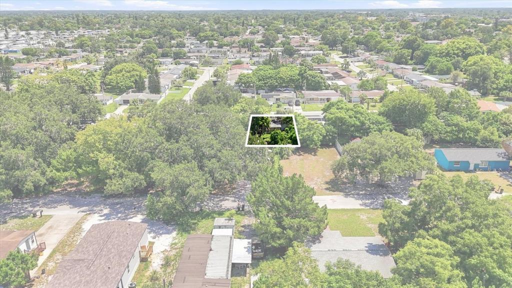 An aerial view shows a residential lot with a small house highlighted by a white border — 8844 MIKE STREET, PORT RICHEY, FL