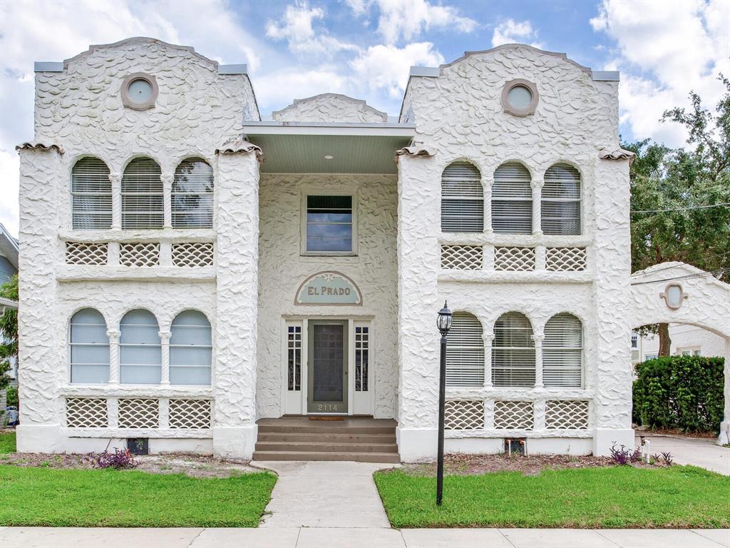 A two-story white stucco building with arched windows and a central entrance labeled El Prado — 2114 W DEKLE AVENUE UNIT 4, TAMPA, FL