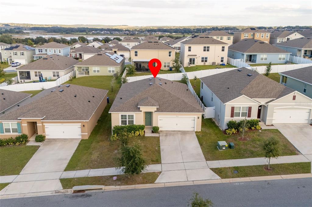 An aerial view shows a suburban single-story house with a garage and a red pin — 9537 BLACK WALNUT DRIVE, CLERMONT, FL