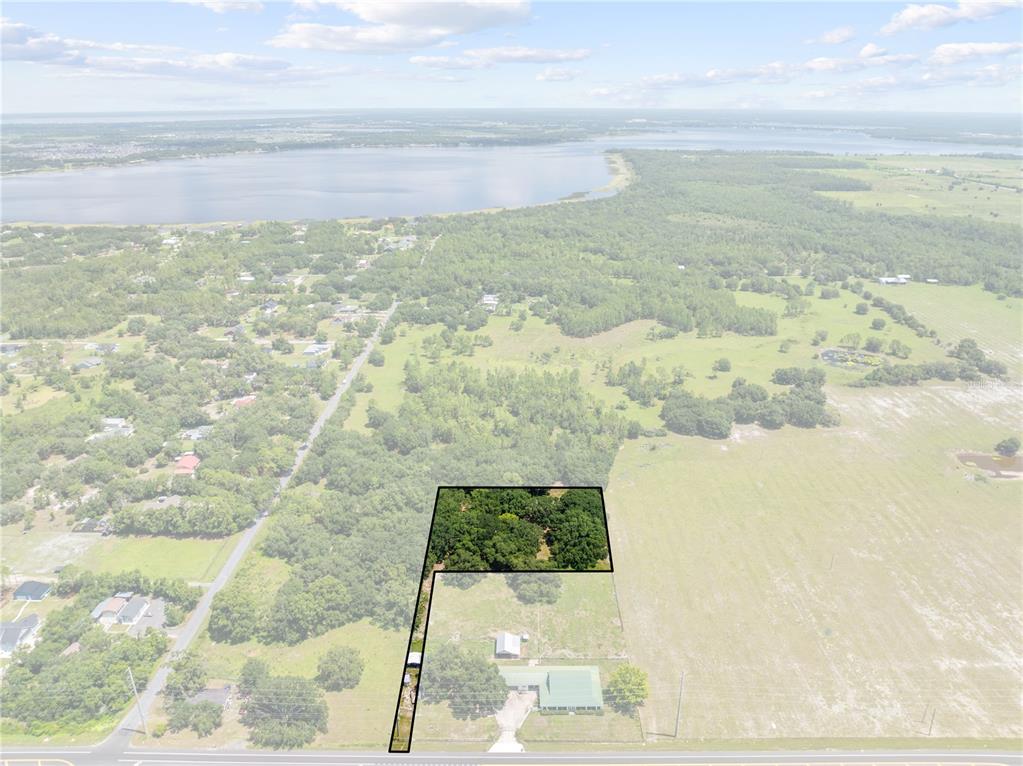 An aerial view shows a rectangular property outline highlighting a wooded area and a house — 0 HICKORY TREE RD. SAINT CLOUD, FL UNIT 34772, ST CLOUD, FL