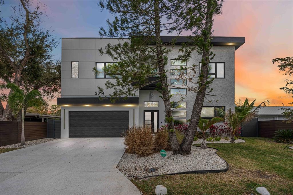 A modern two-story house features a gray facade, a dark garage door, and a driveway — 2314 PROSPECT STREET, SARASOTA, FL