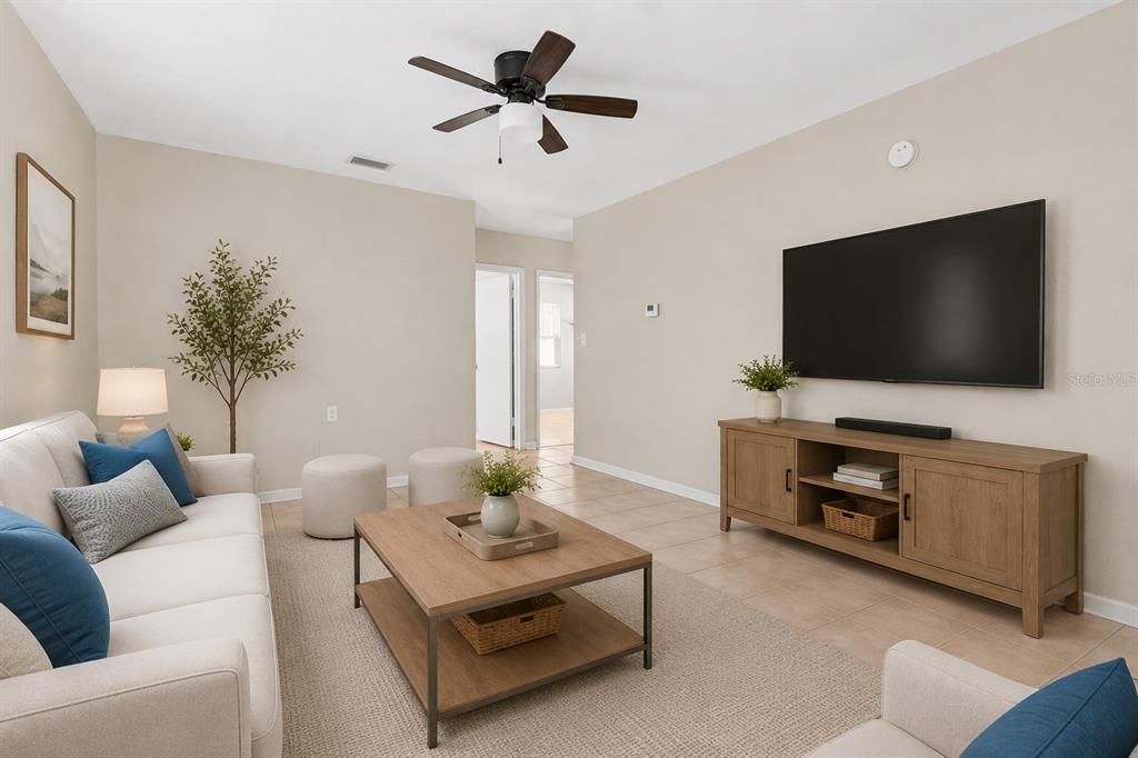 A single-story gray house with a front porch, a gravel driveway, and a concrete walkway — 1946 15TH AVENUE S, ST PETERSBURG, FL