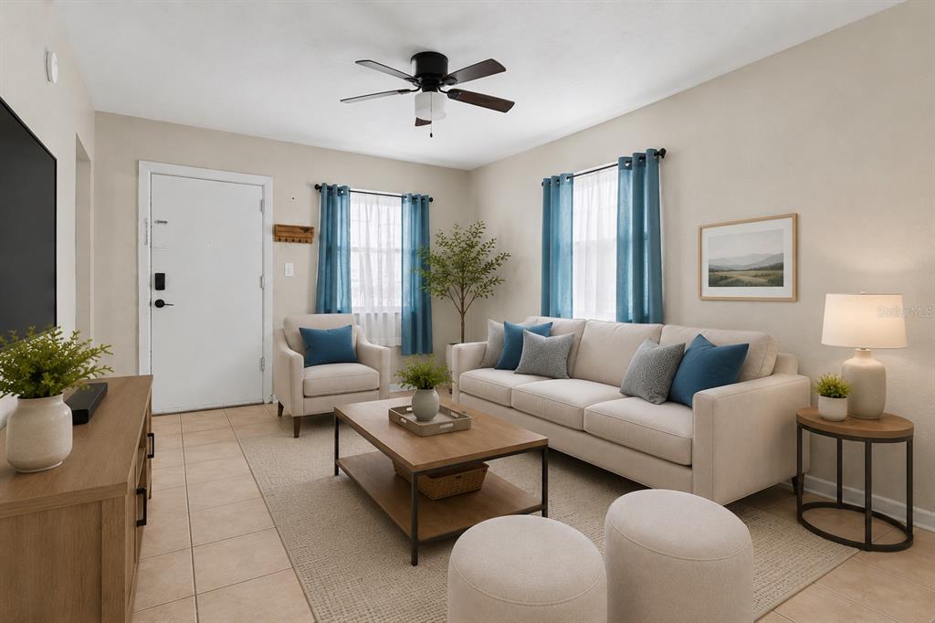 A living room features a television, media console, sofa, armchairs, and a coffee table — 1946 15TH AVENUE S, ST PETERSBURG, FL