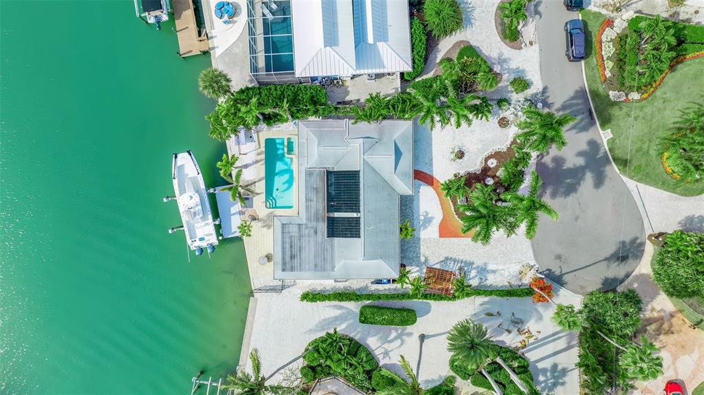 An aerial view of a single-story house with a paved driveway and palm trees — 922 CASEY COVE DRIVE, NOKOMIS, FL