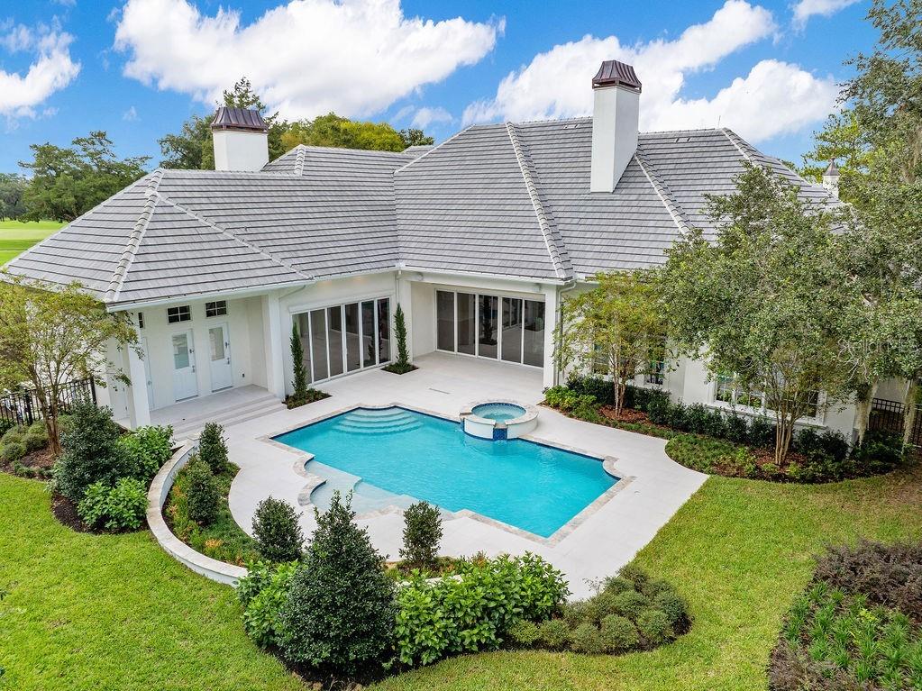 An aerial view of a white house with a gray tile roof and a pool — 4015 NW 85TH TERRACE, OCALA, FL