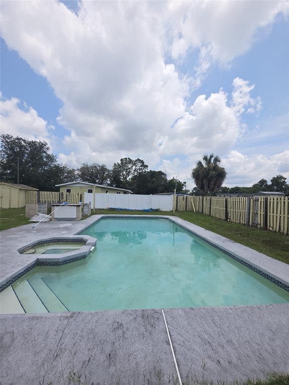 A single-story gray house with a carport and a large front lawn — 802 CRAWFORD STREET, DELTONA, FL