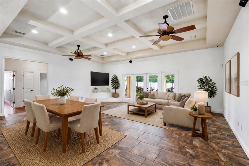 A yellow stucco house exterior features a paved walkway leading to a covered front entrance — 1113 MYRTLE BREEZES CT, FRUITLAND PARK, FL