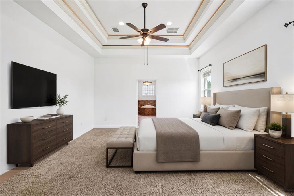 A hallway with tile flooring leads to a living area with a ceiling fan — 1113 MYRTLE BREEZES CT, FRUITLAND PARK, FL