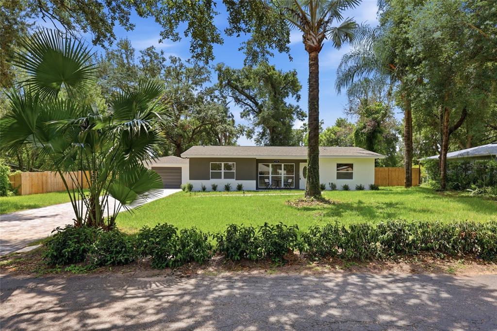 A single-story house with a two-tone exterior, a palm tree, and a paved driveway — 238 PRESCOTT DRIVE, ORLANDO, FL